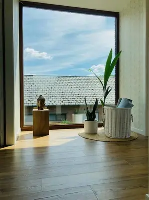 a room with a large window with a potted plant at Sweet Valley View - Architectenwoning in Zutendaal