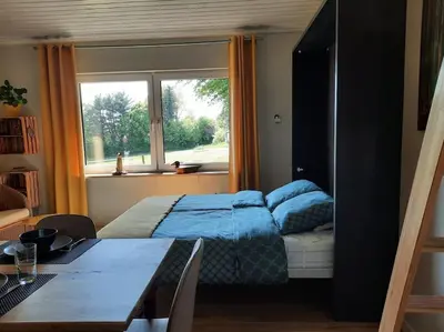 a bedroom with a bed and a window at WalHOME: Hohes Venn, 3 Grenzen, Natur in Walhorn