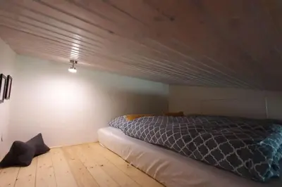 a bedroom with a bed and a wooden floor at WalHOME: Hohes Venn, 3 Grenzen, Natur in Walhorn