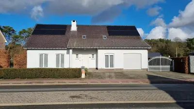 a white house with solar panels on the roof at MARINA in Houthalen-Helchteren