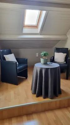 a living room with a table and two chairs at MARINA in Houthalen-Helchteren
