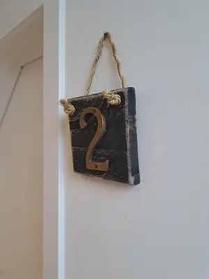 a sign with the number two hanging on a door at Hotel Apartments Belgium 5 - HAB 5 in Balen