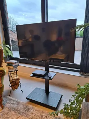 a flat screen tv in a living room with a window at Hotel Apartments Belgium 5 - HAB 5 in Balen