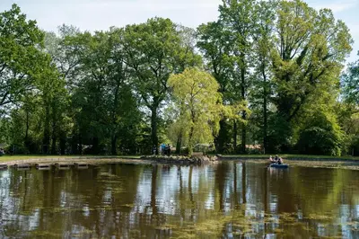 two people in a boat in a pond in a park at Jocomo Parc in Lanaken