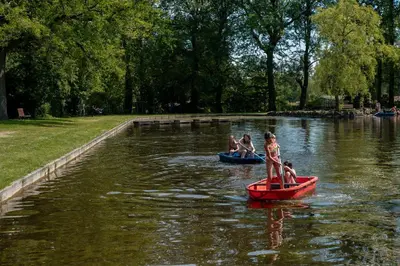 a group of people riding on boats in the water at Jocomo Parc in Lanaken