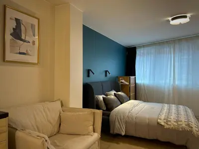 a living room with a bed and a couch at Suite luxueuse aux Guillemins in Liège