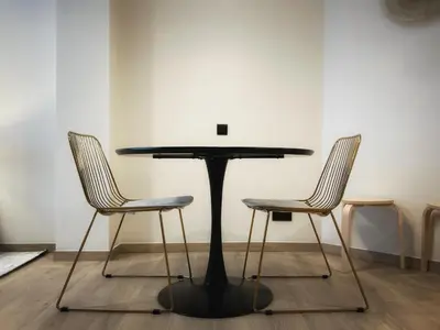 a black table and two chairs in a room at Suite luxueuse aux Guillemins in Liège