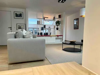 a living room with a couch and a table at Le contemporain - Plein centre, place du Marché in Liège
