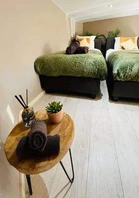 a living room with a bed and a coffee table at Appartement tropical in Liège