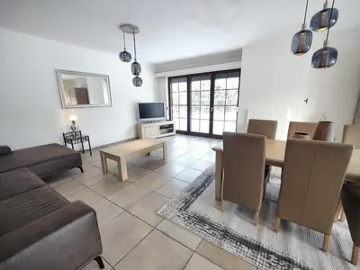 a living room with a couch and a table at Sluizen aan de Jeker in Tongeren