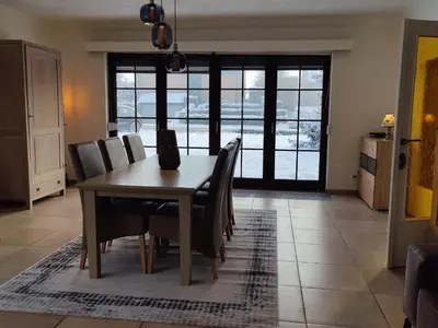 a dining room with a wooden table and chairs at Sluizen aan de Jeker in Tongeren