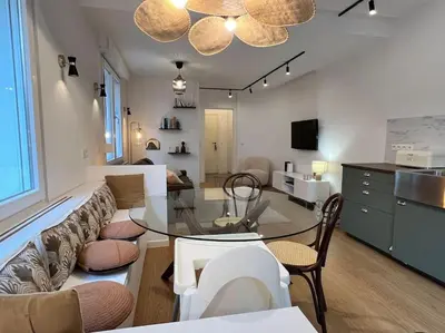 a living room with a couch and a glass table at Havre des Anges - Pont de Fragnée, Guillemins in Liège