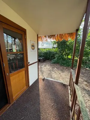 an entrance to a house with a wooden door at Pipowagen de Zwaan in Hoge Kempen nabij Maastricht in Lanaken