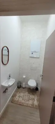 a bathroom with a toilet and a sink at Au pied du théâtre in Verviers