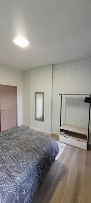 a bedroom with a large bed and a mirror at Au pied du théâtre in Verviers