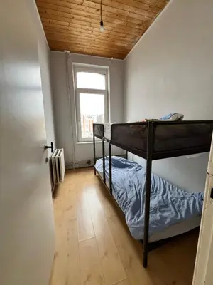 a bedroom with two bunk beds and a window at Le Minimum in Liège