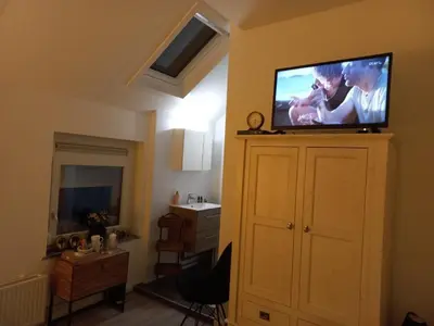 a living room with a flat screen tv on a wall at Casa Barata in Riemst