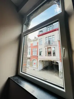 a view of a building from a window at Charmant petit appartement. in Liège