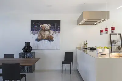a teddy bear sitting on a painting on the wall at B&B Opus35 in Montzen