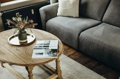 a living room with a couch and a coffee table at Au pied du Pré by WelcHome in Verviers