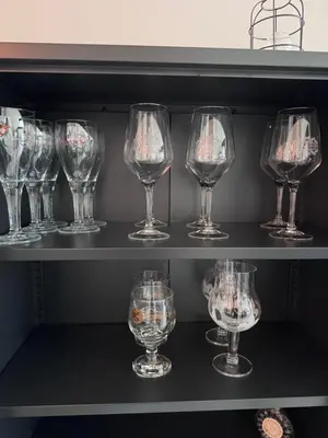 a row of wine glasses on a shelf at Stylish Home near Maastricht Alicias house in Lanaken