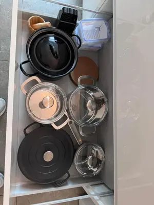 a bunch of pots and pans in a drawer at Stylish Home near Maastricht Alicias house in Lanaken