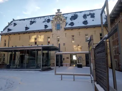a large building with snow on the roof at KolMojen in Sint-Truiden