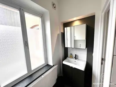 a bathroom with a sink and a large window at Le Loft liégeois - Au coeur de la cité in Liège