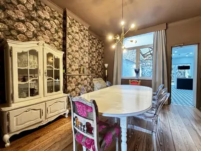 a dining room with a white table and chairs at Maison du Roi in Liège