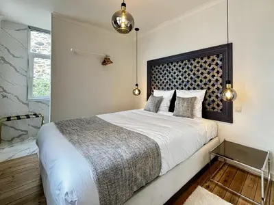 a bedroom with a large bed and a shower at Maison du Roi in Liège