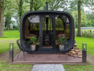 a gazebo with two chairs on a wooden deck at Maison Idyllique in Bree