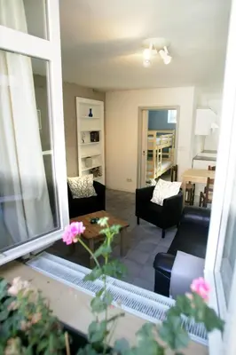 a living room with a couch and a table at Apartment 't Maanhof in Gingelom
