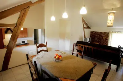 a kitchen and dining room with a table and chairs at Apartment 't Maanhof in Gingelom