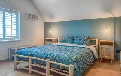 a bedroom with a bed with a blue wall at Looshof in Helchteren