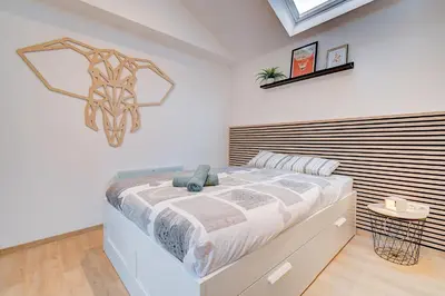 a bedroom with a bed with a statue of a horse on the wall at LIÉGE - Le cocon de Chênée in Chênée