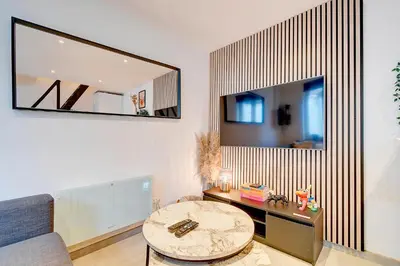 a living room with a table and a mirror at LIÉGE - Le cocon de Chênée in Chênée