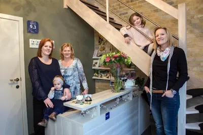 a group of women standing around a counter in a store at B&B De Watering in Lommel