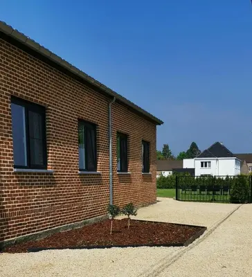 a brick building with a small tree in front of it at Ten Velde - vakantiewoning 12 personen - sauna - bubbelbad in Hoeselt