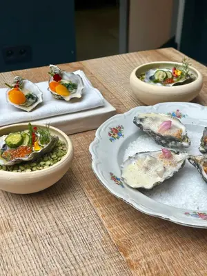 a table with three plates of food on it at Hotel Het Menneke in Hasselt