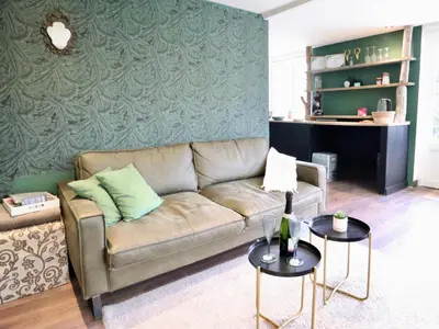 a living room with a couch and two tables at Sonnig Bungalow in Lanaken