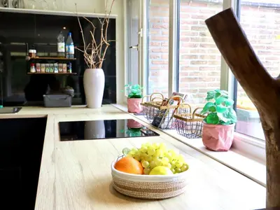 a bowl of fruit on a counter in a kitchen at Sonnig Bungalow in Lanaken