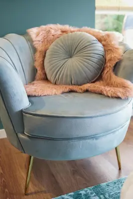 a blue chair with a pillow in a living room at Lacuna VITA by Sonnevijver Residences in Lanaken