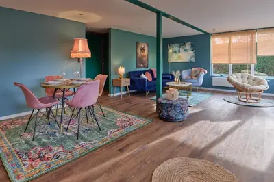 a living room with a table and chairs at Lacuna VITA by Sonnevijver Residences in Lanaken