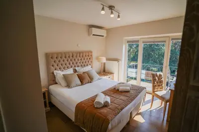 a bedroom with a large bed with two towels on it at Hôtel Au Comte de Mercy in Oupeye