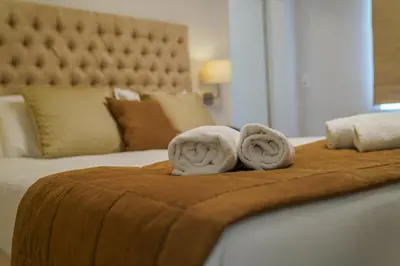 a bed with two towels on top of it at Hôtel Au Comte de Mercy in Oupeye