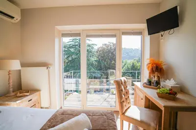 a living room with a view of a balcony at Hôtel Au Comte de Mercy in Oupeye