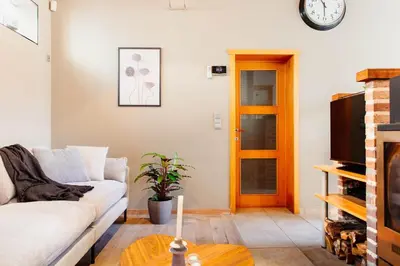 a living room with a couch and a tv at 8P 4B Authentic house with playroom and infrared sauna in Bilzen
