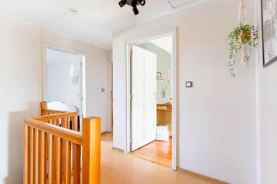 a hallway with a stairway leading into a home at 8P 4B Authentic house with playroom and infrared sauna in Bilzen