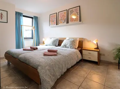 a bedroom with a bed with two towels on it at De Millenniumhoeve (Jean) in Riemst