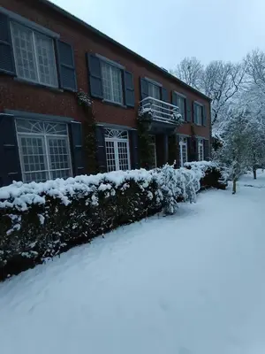 a house with snow on the ground in front of it at Sleep and Dream in Liège